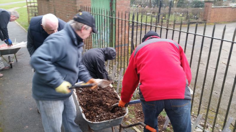 Rotarians at work planting tree saplings in the new cemetery extension.