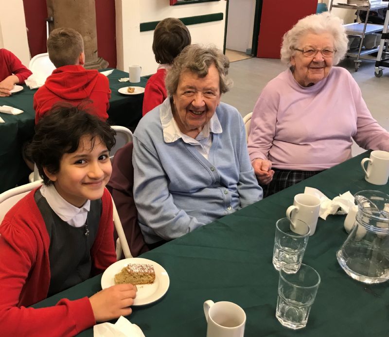 left to right (attached): 11 year-old Safa Ahmed from Chorlton Church of England Primary School joins Winifred Richards and Margaret Bell for lunch at the St Clement’s Community Lunch Project.