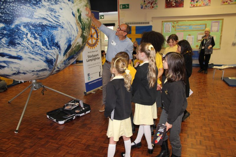 Jose Antonio from Venezuela pointing out the location of his country on the inflatable Earth with NASA satellite imagery