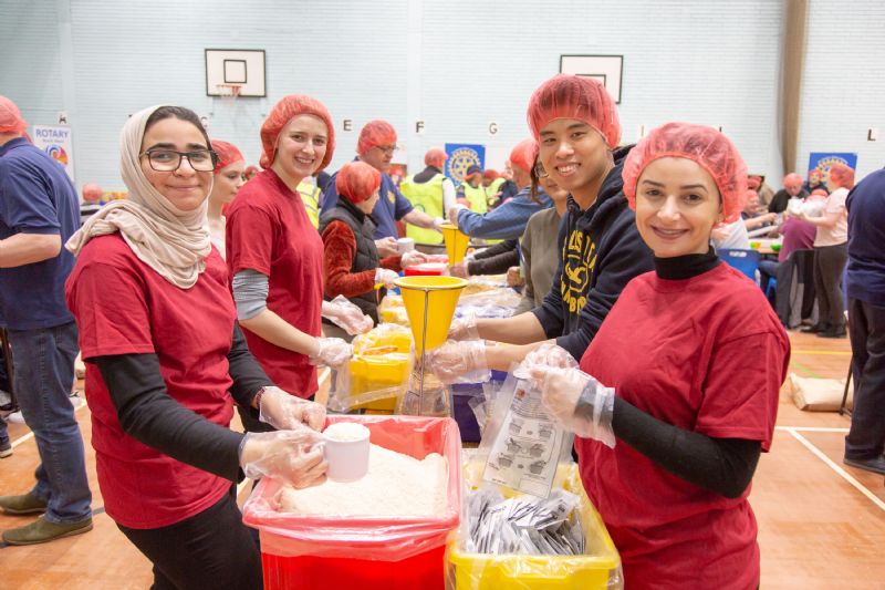 Members of Manchester International Rotaract at one of the packing tables.