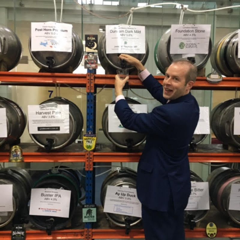 Local MP Jonathan Reynolds helping himself to the barrel he sponsored.