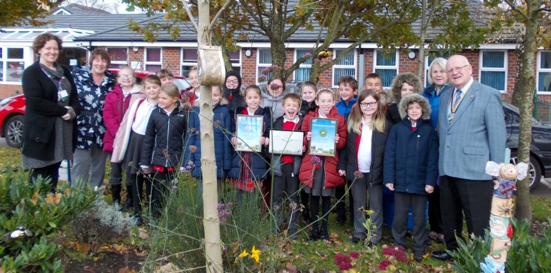 left to right:   Teachers, children with Wigan Rotary President Mervyn Reeves in the grounds of Millbrook Primary School