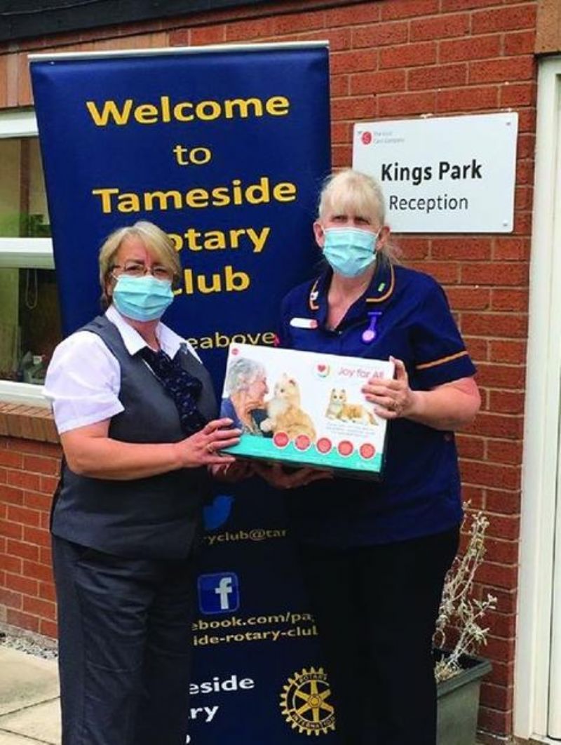 Here pictured are Deputy Manager Rose and Administrator Janice receiving the Robotic Cat.