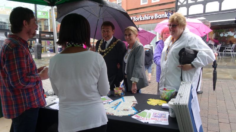 Photo of the Mayor and Mayoress, accompanied by Wigan Rotary President Maureen Billsborough visiting stall holders.