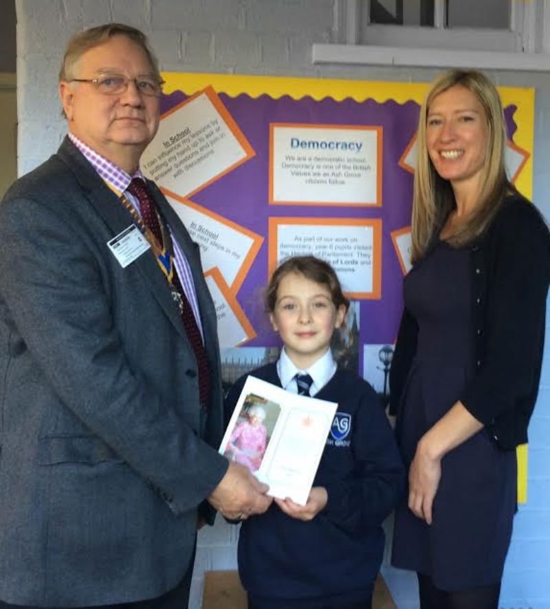 Ray Kramer, Macc Castles Rotary President, with Ash Grove Pupil Grace Bailey Rushton and the Royal Thank You Card, and Principal Heather Jackson