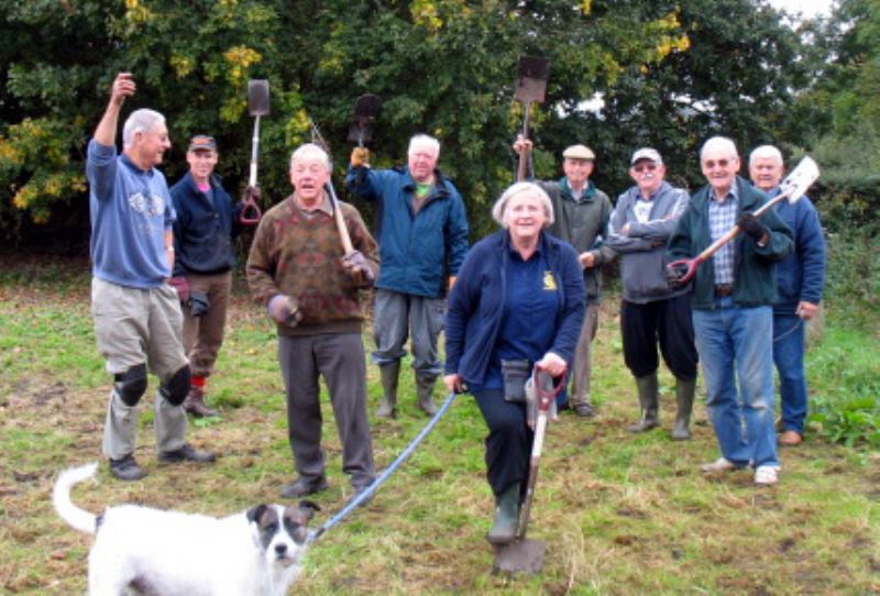 President, Sue Tupman, with “Scamp” and helpers, planting crocus bulbs last October.