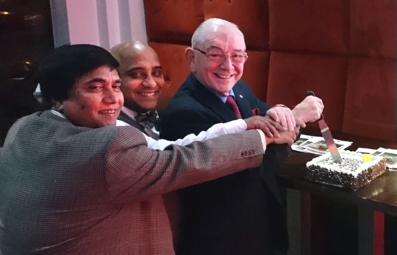 Pictured Anhar Miah, M/Cr Business Man and keen supporter of the project, his friend and Proprietor of the Raj Restaurant Mainul Amin, with the President of Newton & District Jubilee Rotary Club, David Hill, cutting a cake to celebrate 112 yrs of Rotary