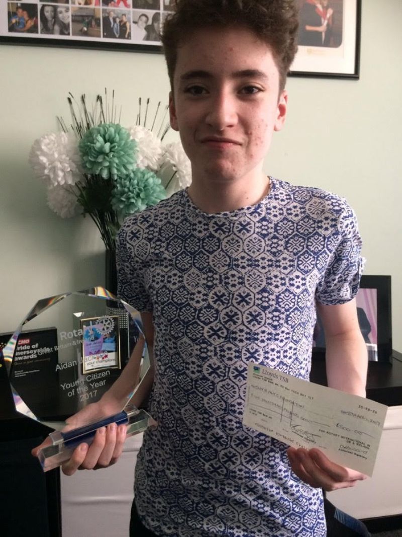 Widnes Rotary nominee, and Rotary Young Citizen Winner, Aidan at his home, with his prize cheque for £500.  Aidan nominated The Olivia Alice Foundation as the recipient of the prize money.