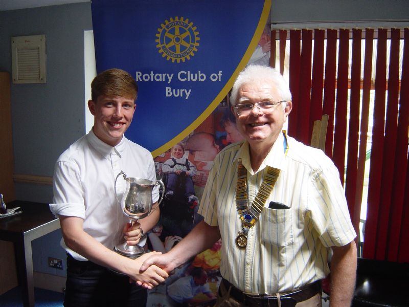 Award Winner – Sean is pictured being presented with the Wilf Ainscow “Ranger” Trophy by Colin Williams, President of Bury Rotary Club