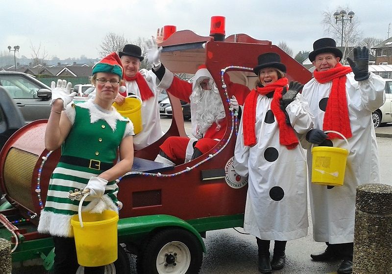 Members of Turton and Bolton-le-Moors Rotary Clubs give a cheery wave around the Christmas sleigh as they make a collection for local and rotary charities outside Morrisons Superstore at Harwood